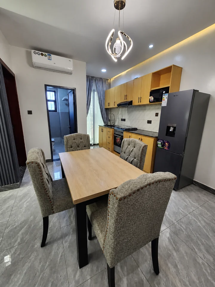 Dining area and equipped kitchen at Elevate Heights Apartment